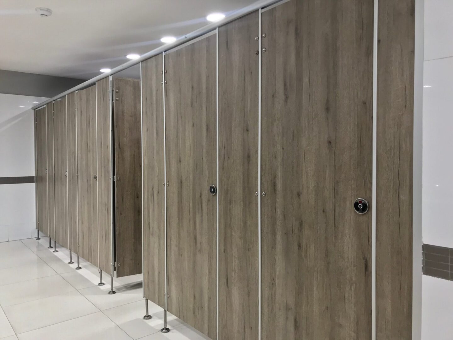 brown-wooden-stall-doors-in-commercial-bathroom