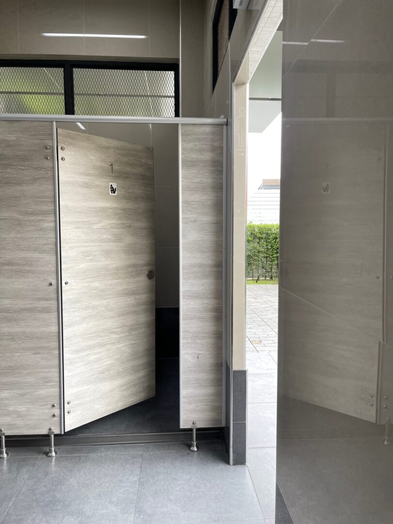 light-wooden-stall-doors-on-commercial-toilet